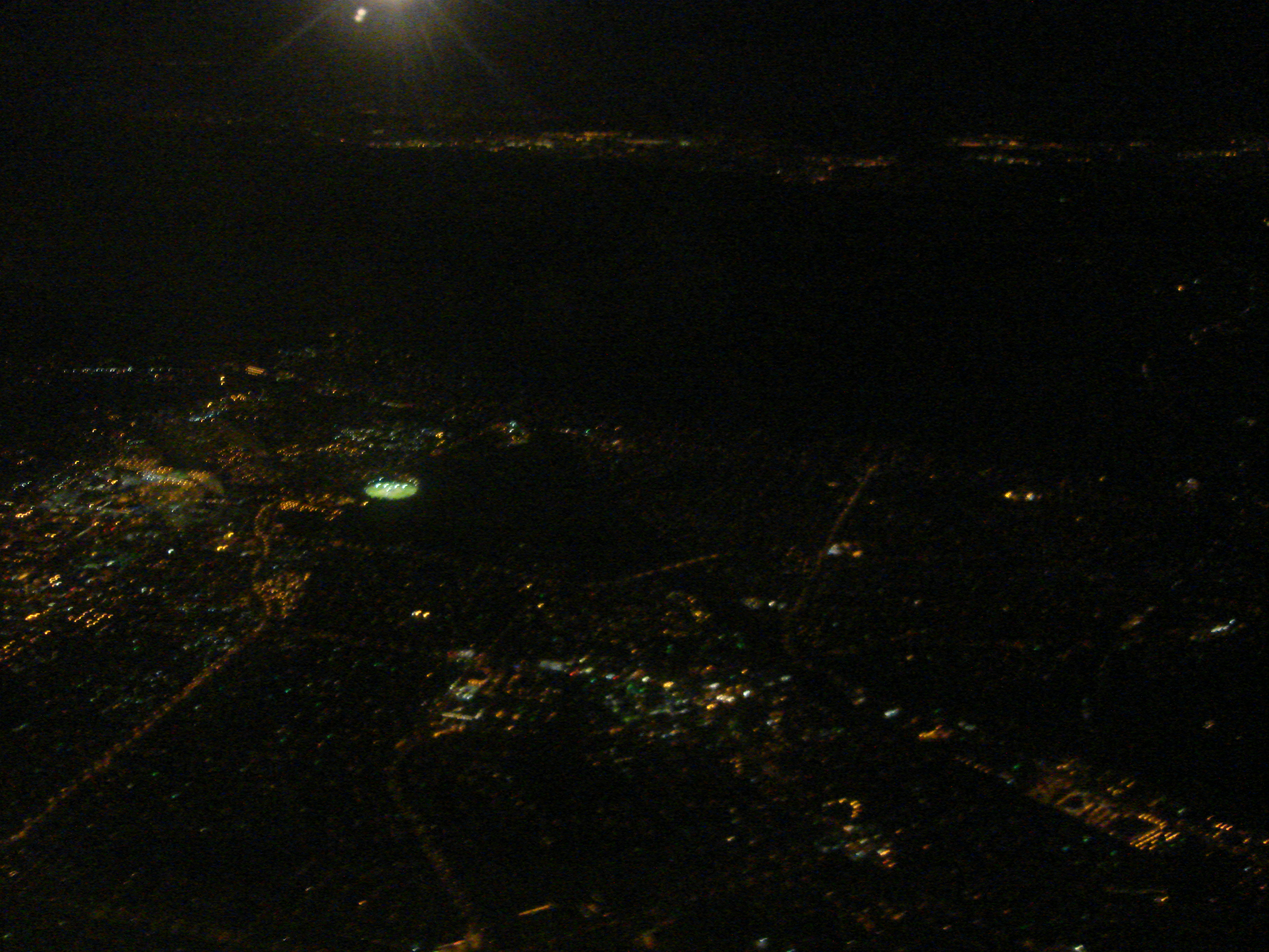 View out the window seat at night (a city in Jersey?)